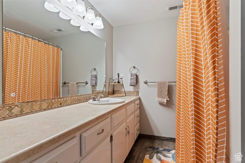 Bathroom featuring vanity and baseboards
