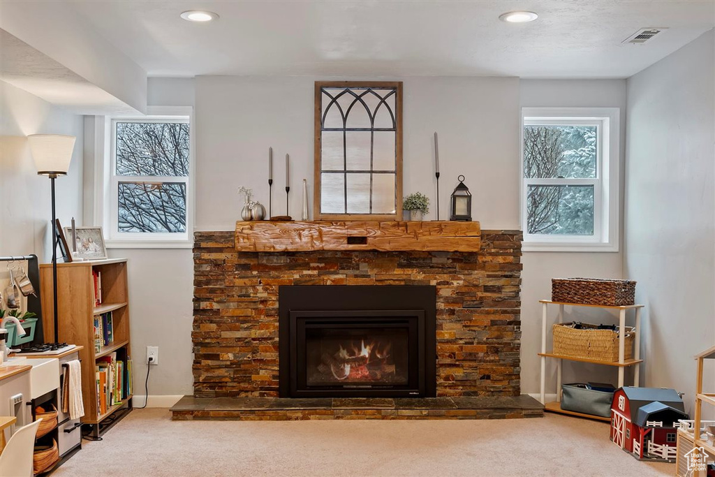Carpeted living room featuring a fireplace, recessed lighting, and baseboards