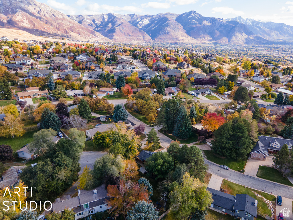 Aerial overview of property's location with mountains and nearby suburban area