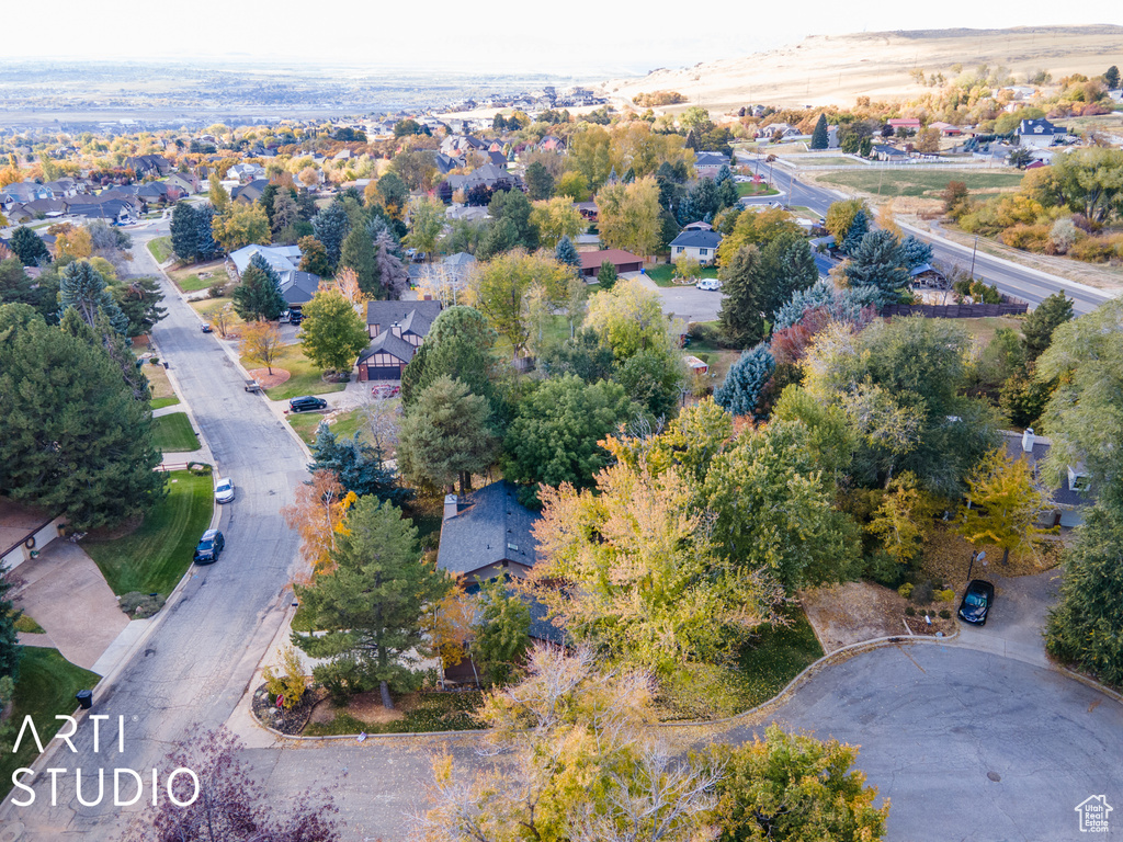 Aerial view of property and surrounding area featuring nearby suburban area