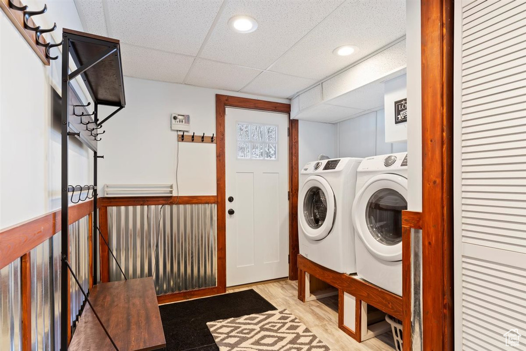 Clothes washing area with separate washer and dryer, recessed lighting, and wood finished floors