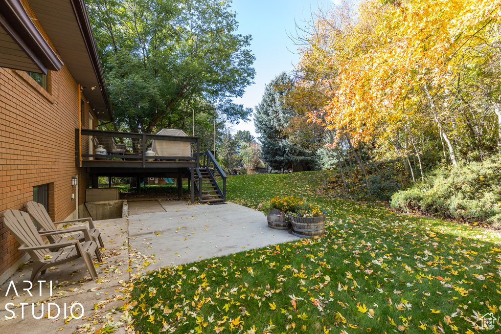 View of patio with stairway and a deck