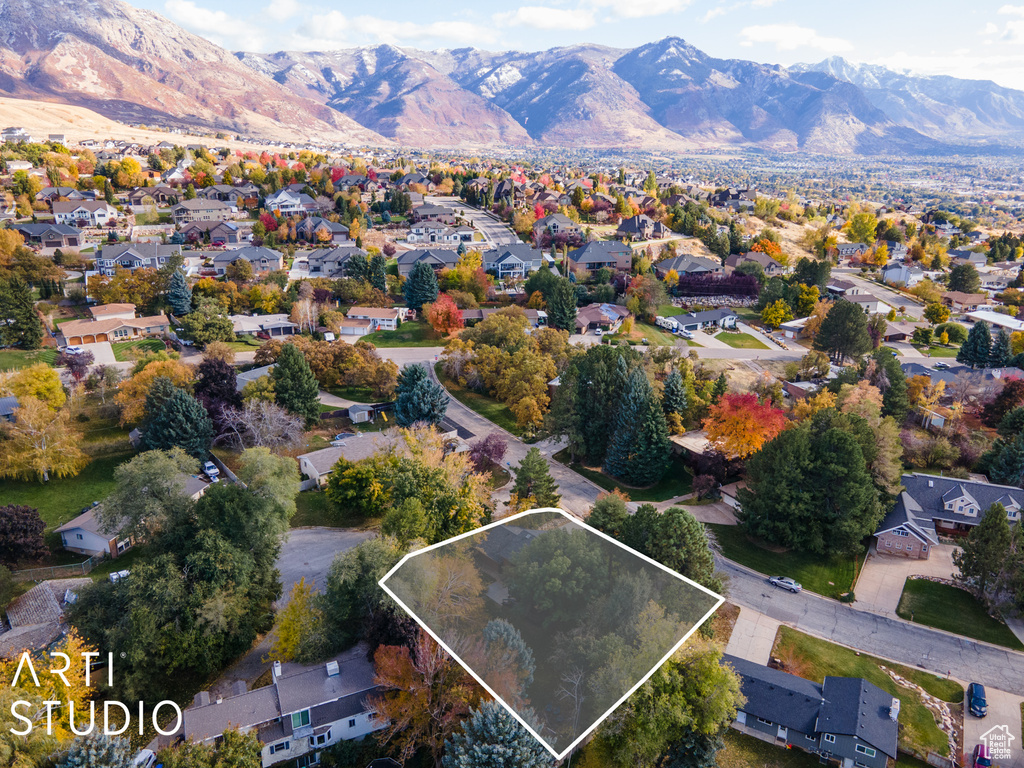 View of property location featuring property parcel outlined, mountains, and nearby suburban area