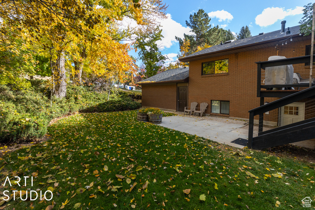 View of green lawn with a patio