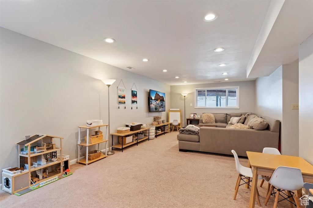Carpeted living room with recessed lighting