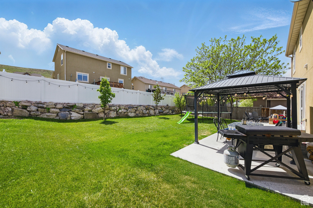 View of yard featuring a patio area and a gazebo