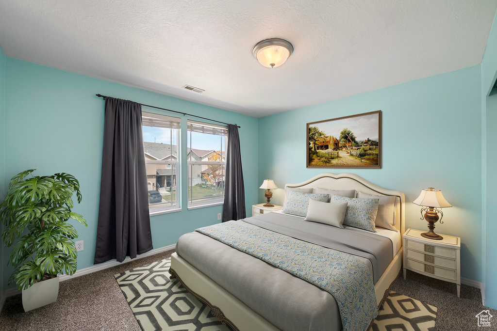 Carpeted bedroom featuring baseboards