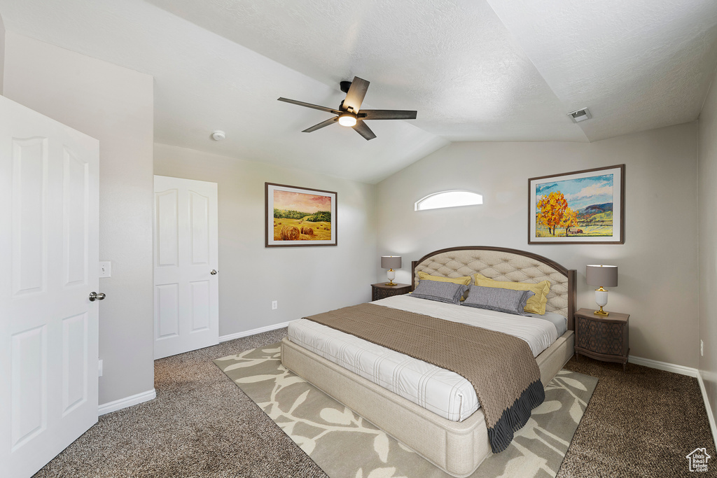 Bedroom with carpet flooring, vaulted ceiling, and a ceiling fan