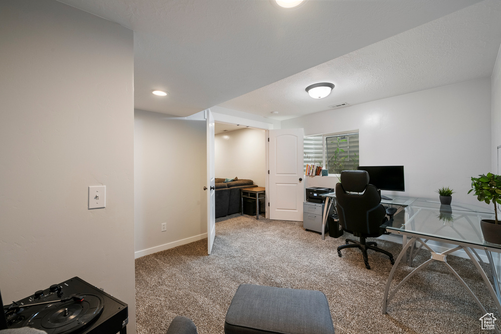Office area featuring light colored carpet, baseboards, and recessed lighting