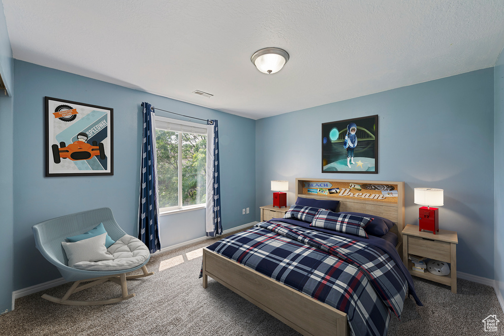 Carpeted bedroom with baseboards