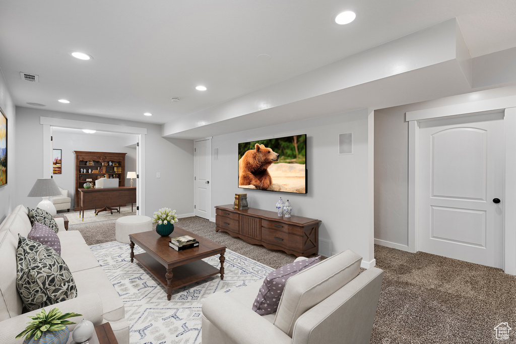 Carpeted living room with recessed lighting and baseboards