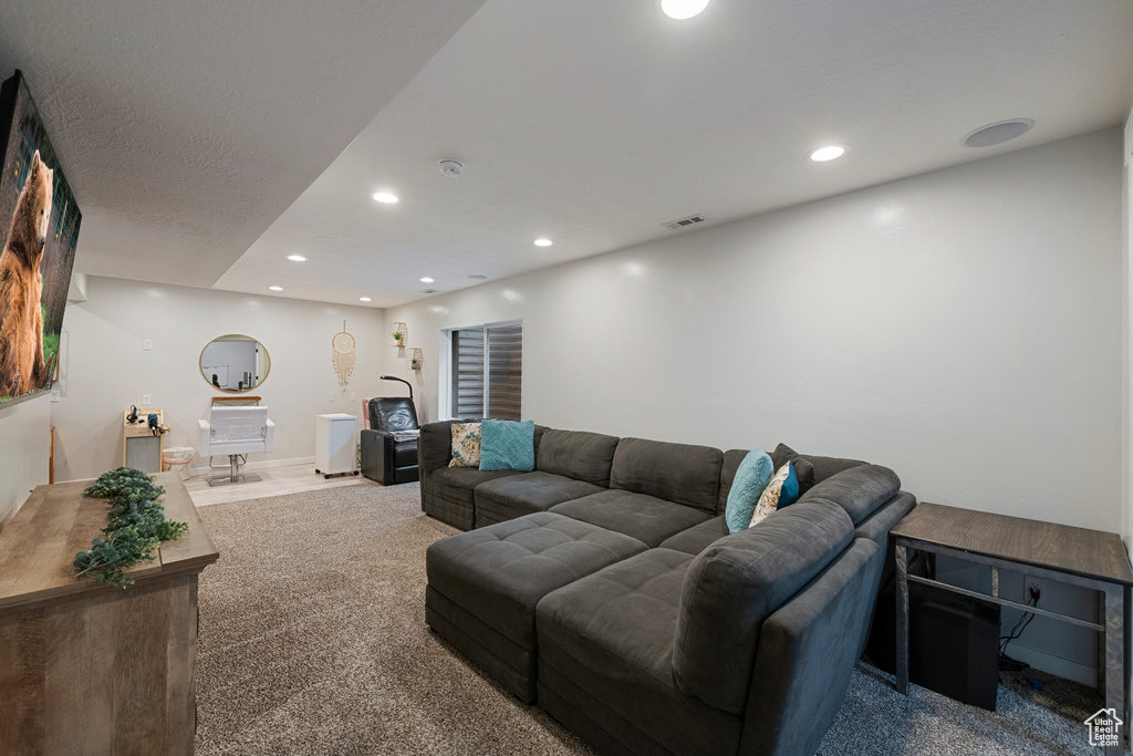 Living room featuring carpet flooring, recessed lighting, and baseboards
