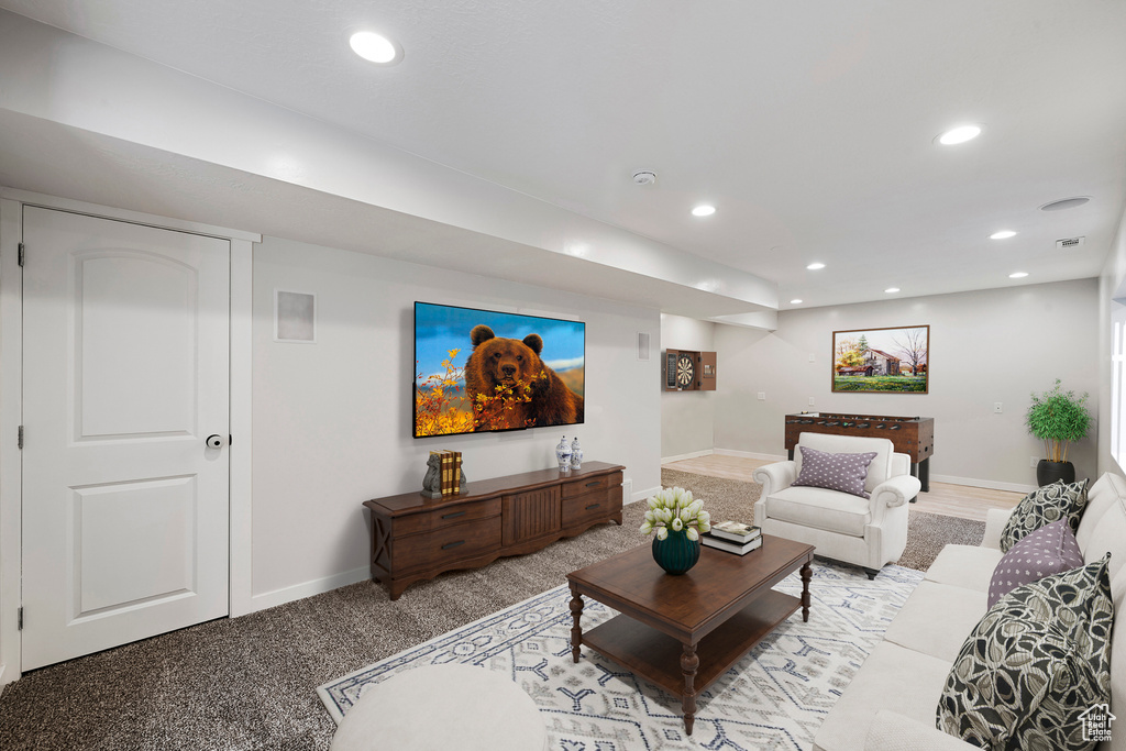 Carpeted living area with recessed lighting