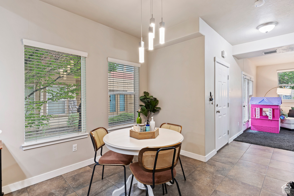 Dining area featuring baseboards and stone finish flooring