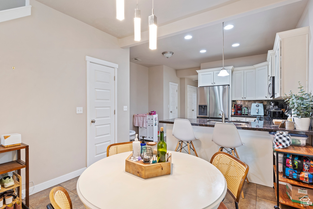 Dining area with recessed lighting and baseboards