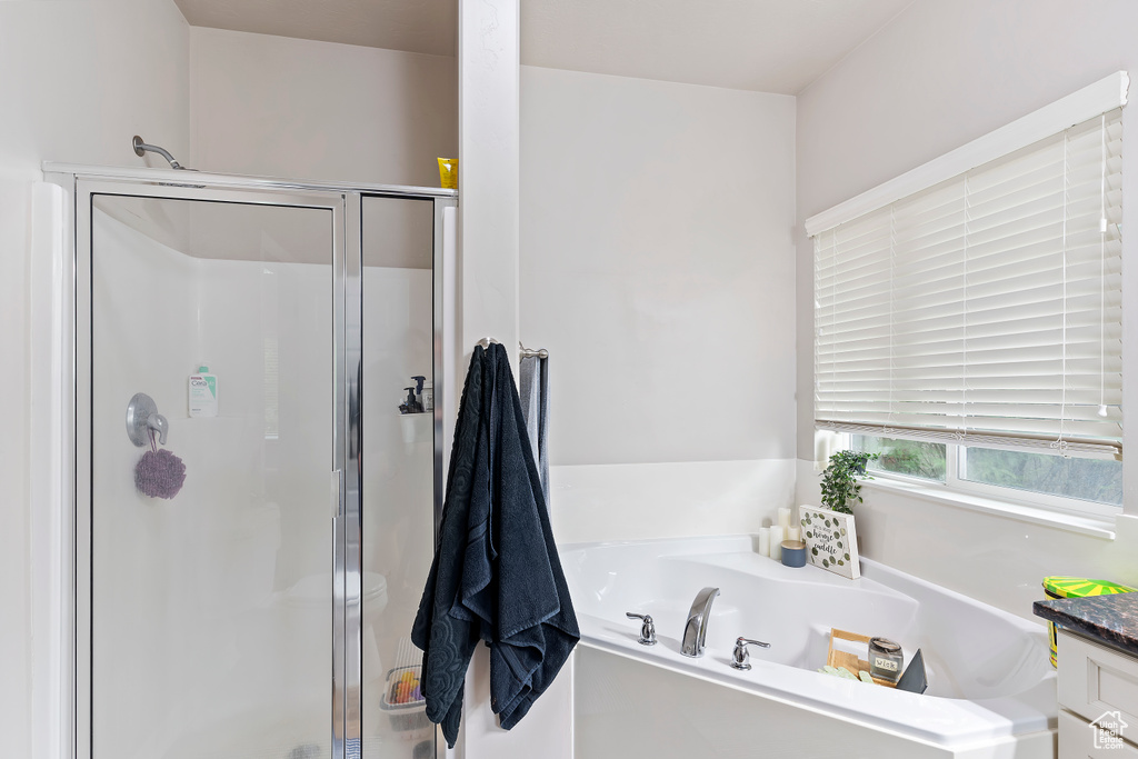 Full bath featuring a shower stall and a garden tub