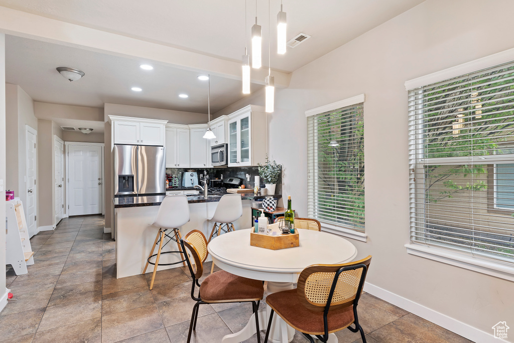 Dining space featuring baseboards and recessed lighting