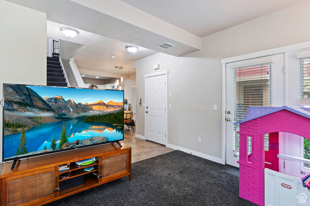 Living room featuring stairway and baseboards