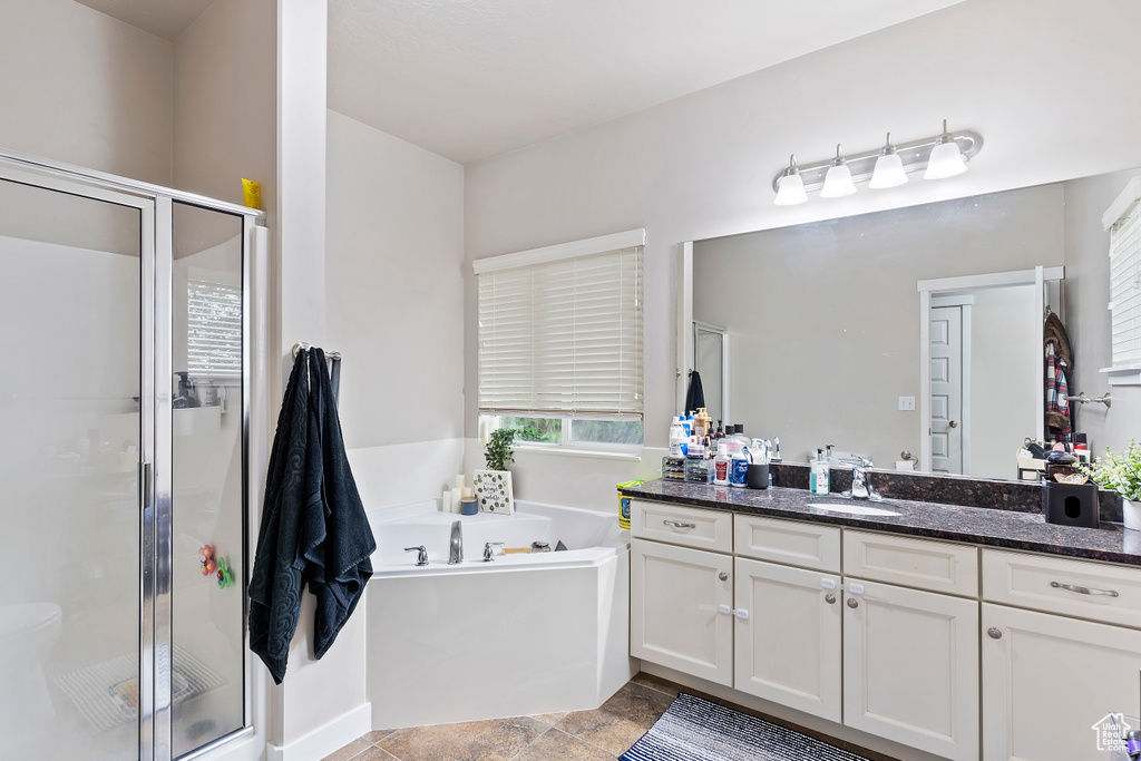 Full bathroom with a shower stall, a bath, and vanity