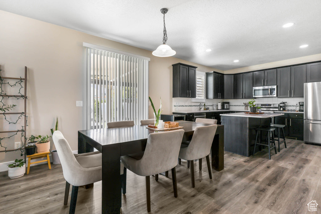 Dining room featuring light wood-style floors and recessed lighting