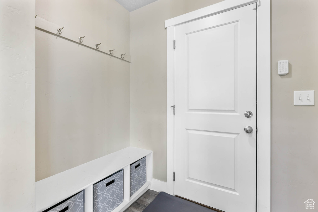 Mudroom with dark wood-style floors and baseboards