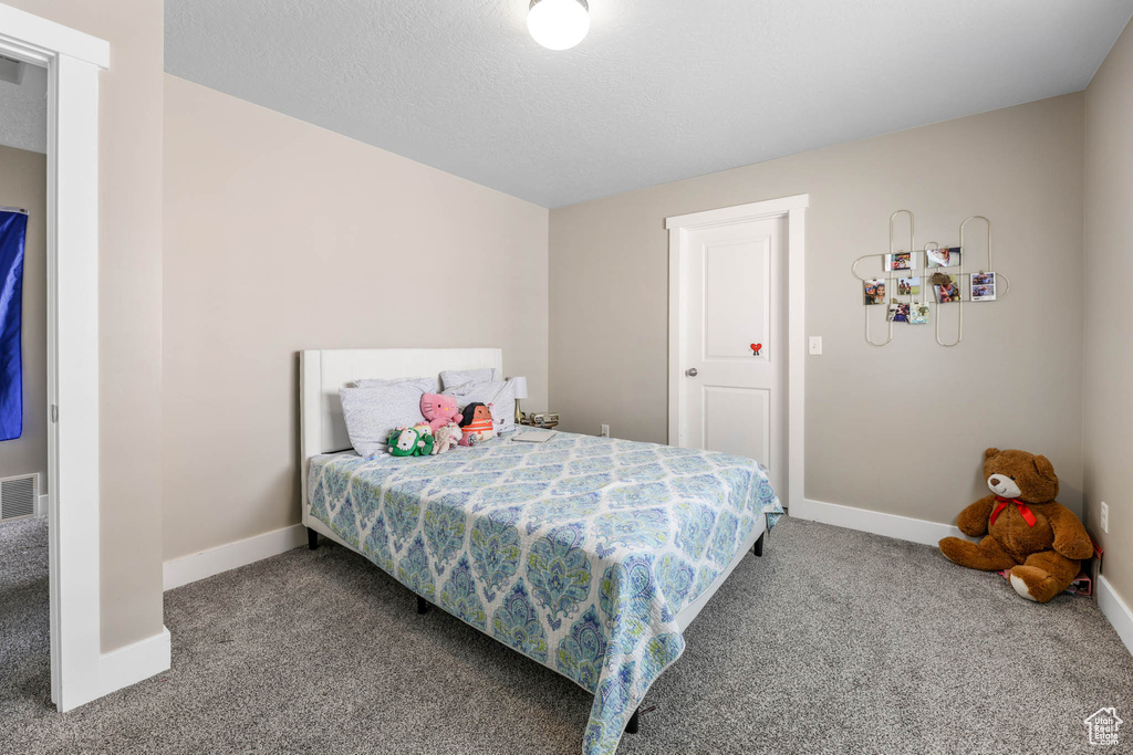 Carpeted bedroom with baseboards