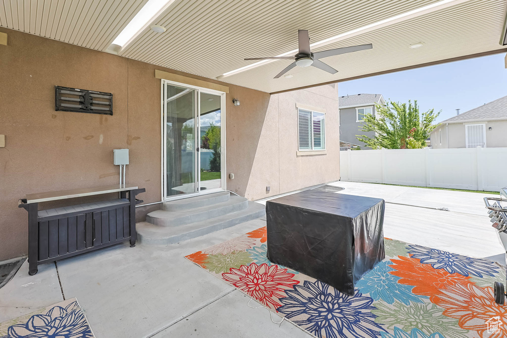 View of patio / terrace featuring fence, ceiling fan, and entry steps