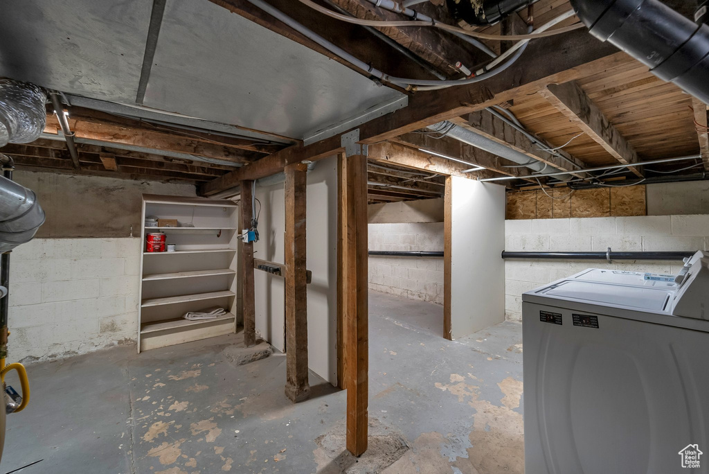Unfinished below grade area featuring independent washer and dryer