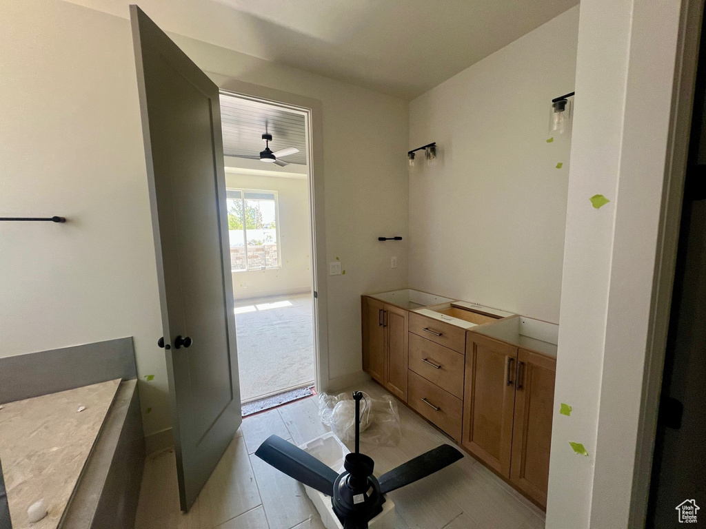 Bathroom with a ceiling fan and vanity