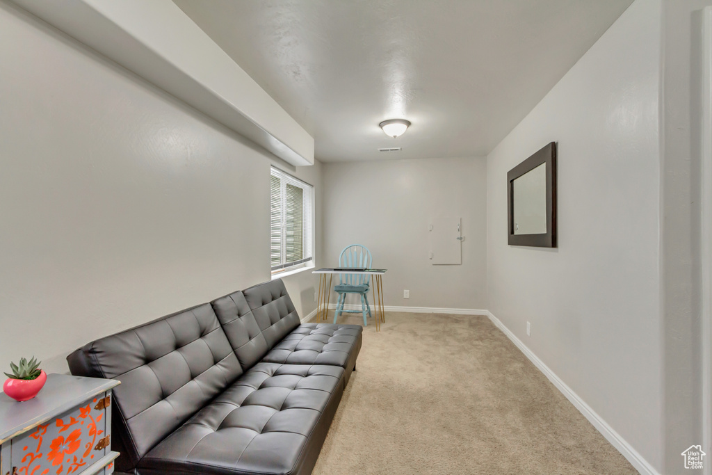 Living area featuring carpet floors and baseboards