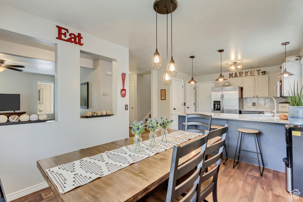 Dining room featuring a ceiling fan and light wood-style flooring