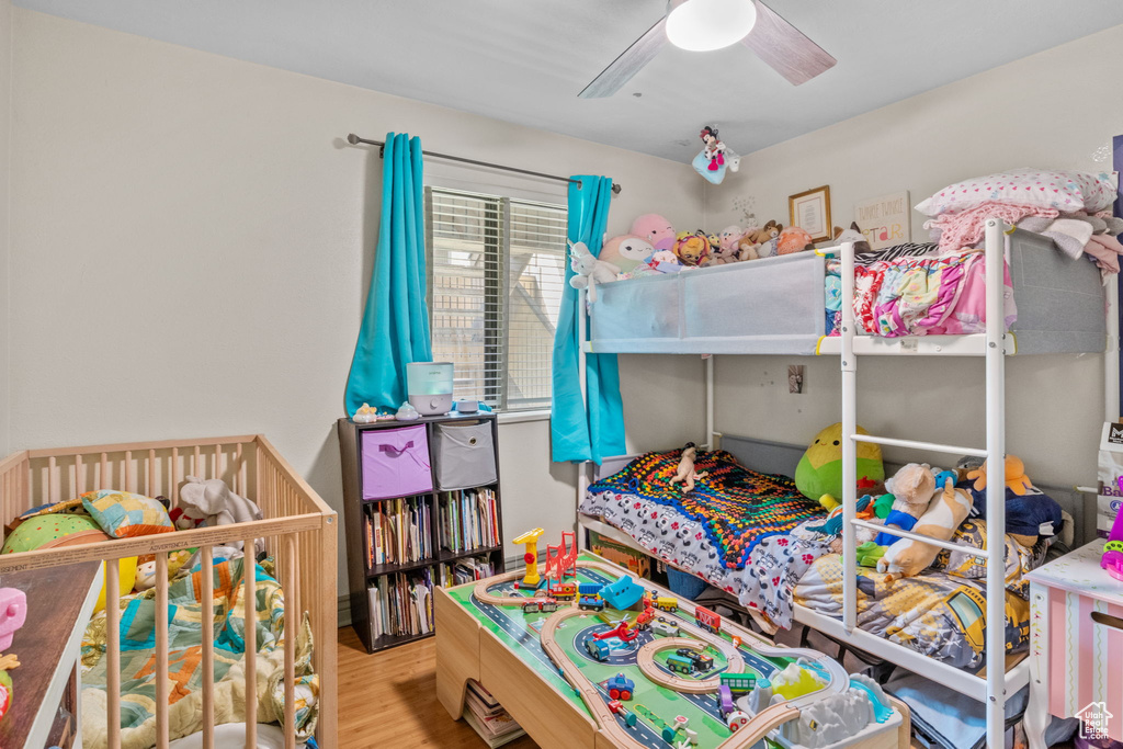 Bedroom with wood finished floors and a ceiling fan