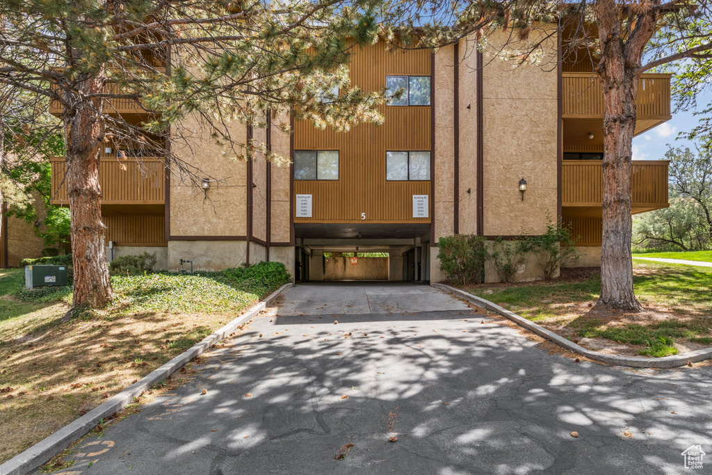 View of building exterior featuring asphalt driveway