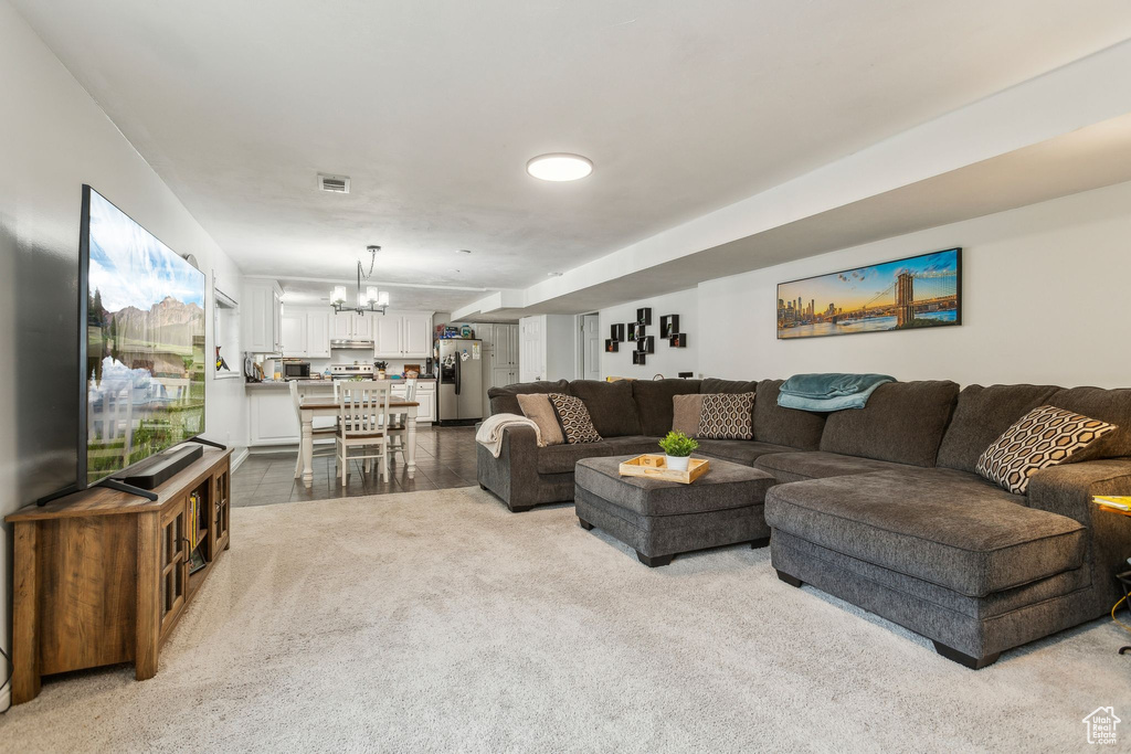 Living room featuring a chandelier and carpet flooring