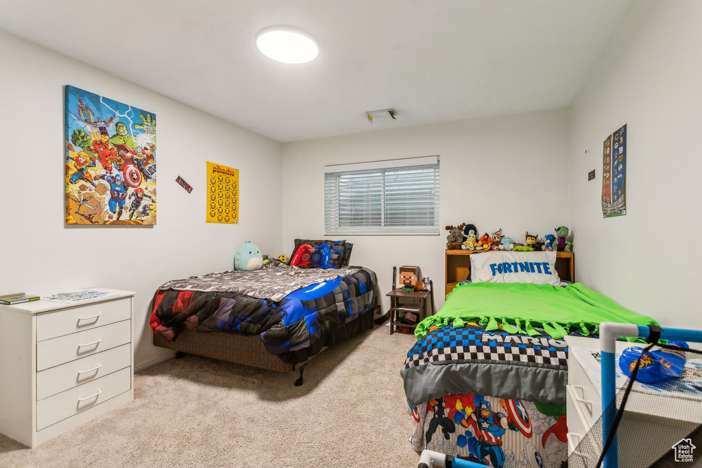 Bedroom featuring light colored carpet