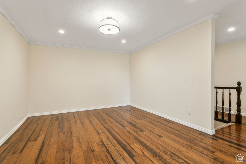 Unfurnished room with wood finished floors, baseboards, recessed lighting, and crown molding