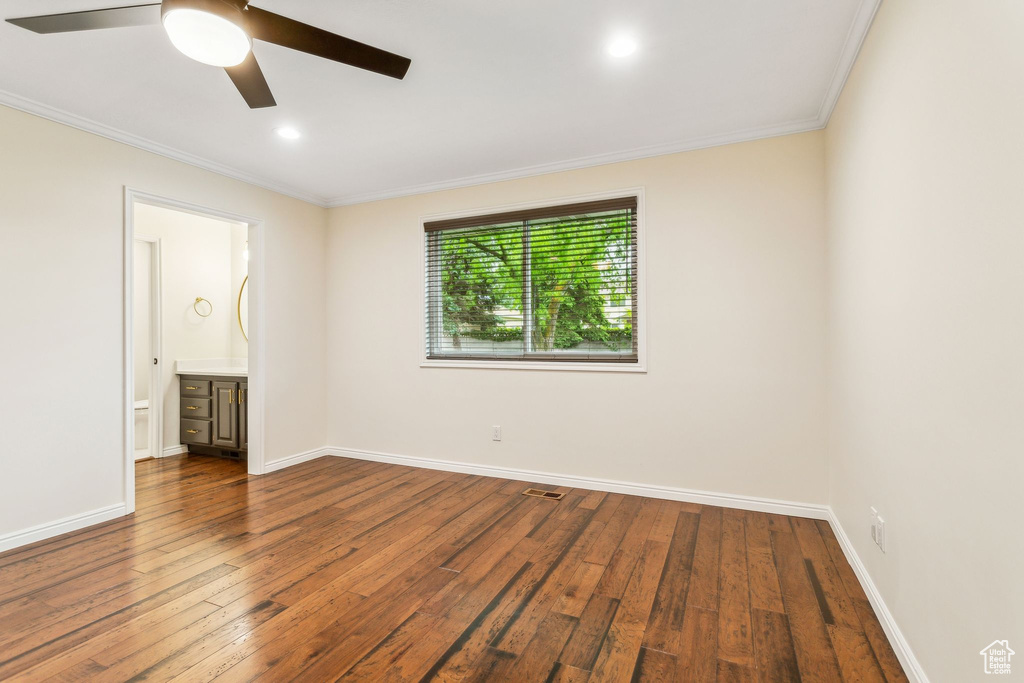 Spare room with ornamental molding, a ceiling fan, dark wood-style flooring, baseboards, and recessed lighting