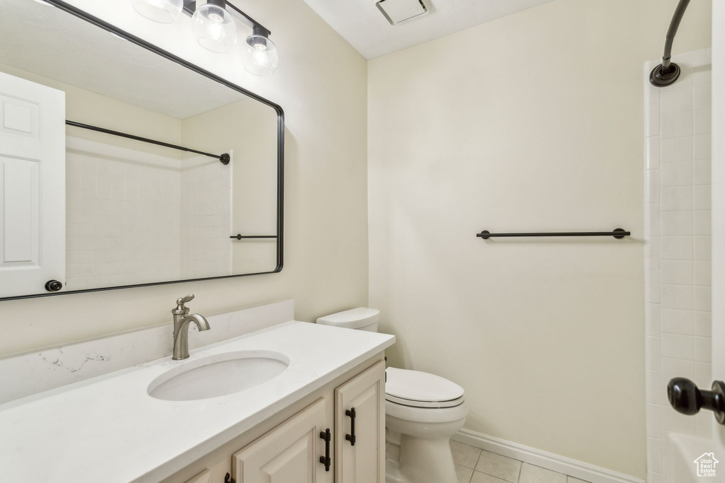 Full bathroom featuring toilet, tile patterned floors, and a shower