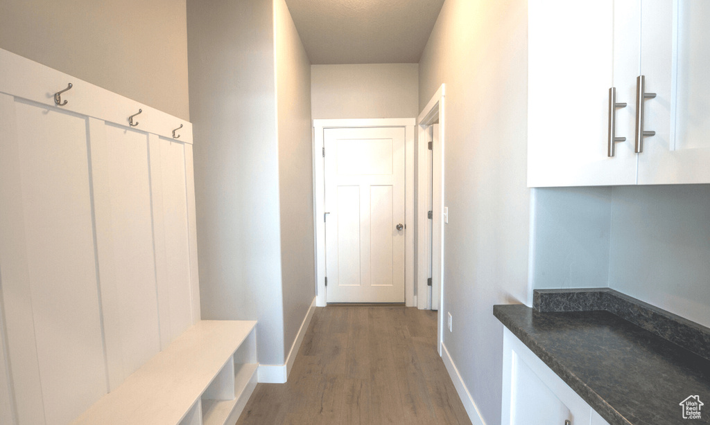 Mudroom with light wood-style flooring and baseboards