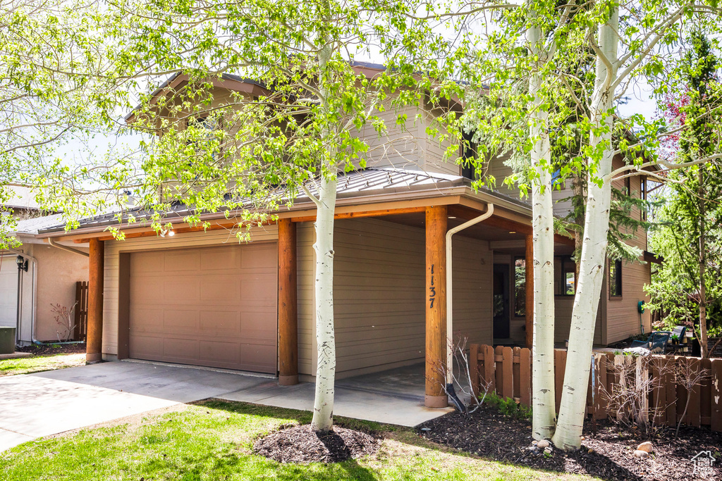 Garage featuring concrete driveway