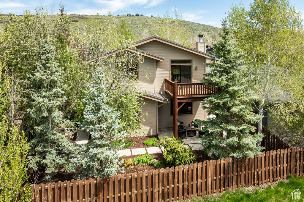 View of front of property with a chimney and a patio area