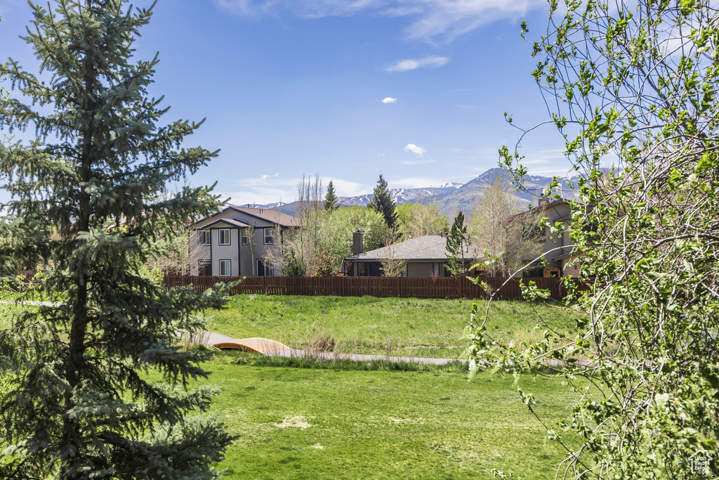 View of yard featuring fence and a mountain view