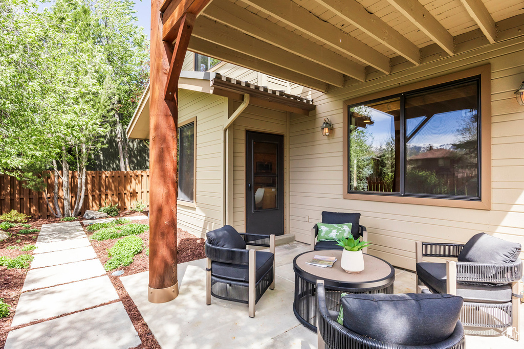 View of patio featuring fence and an outdoor hangout area