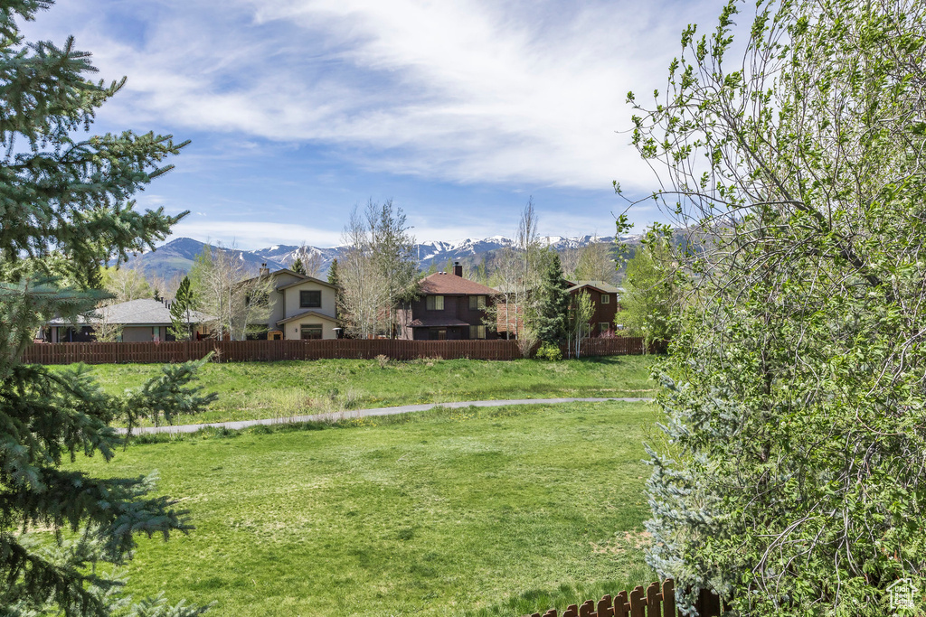 View of yard featuring a mountain view and fence