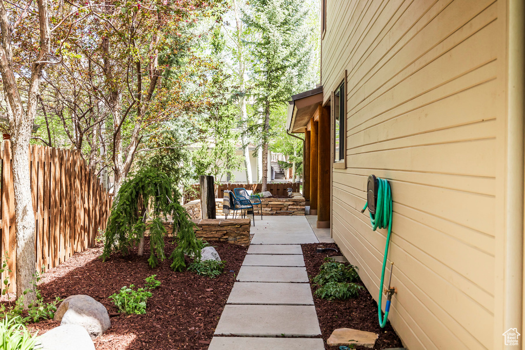 View of yard featuring fence and a patio