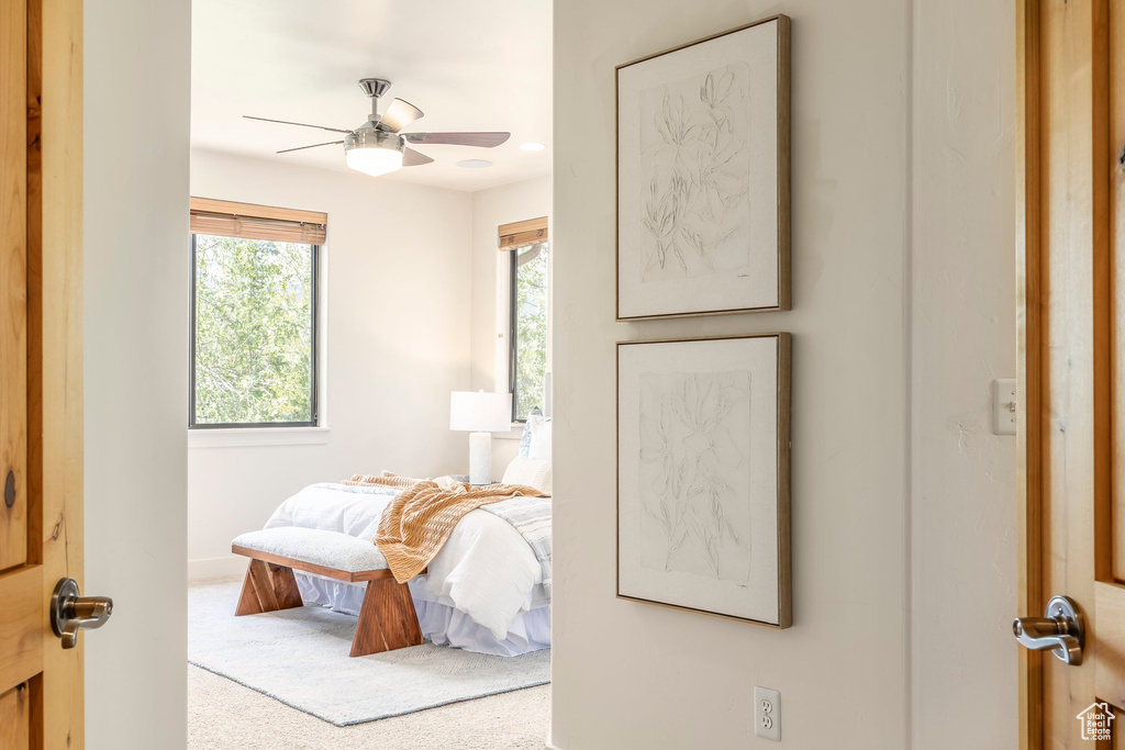 Carpeted bedroom featuring baseboards and ceiling fan