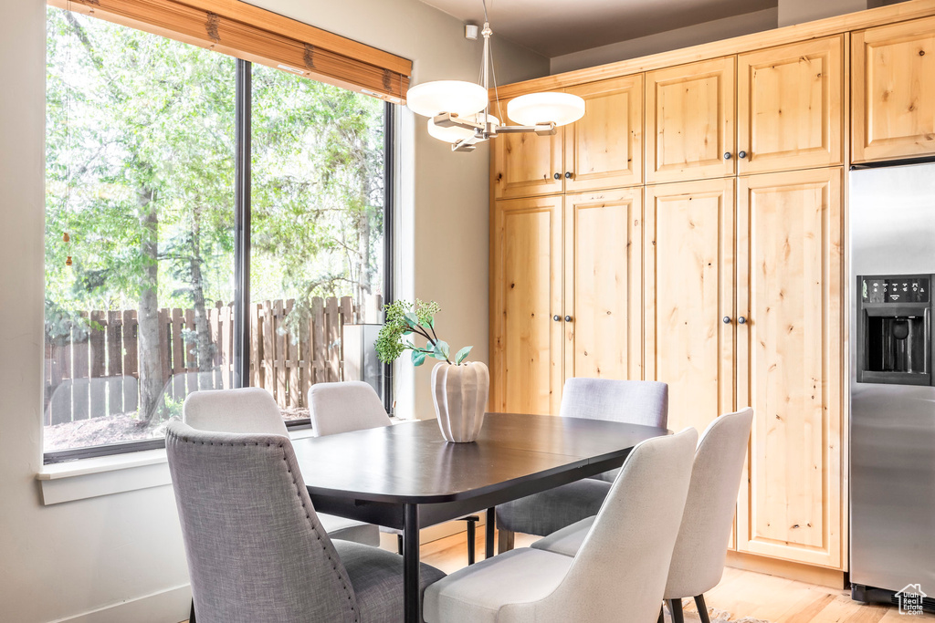 Dining space featuring a chandelier and light wood-style flooring