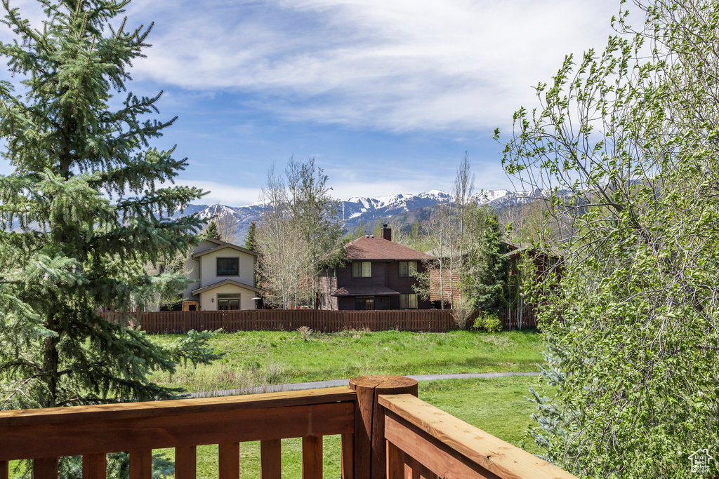 View of yard featuring a mountain view and fence