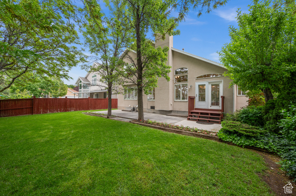 Rear view of house featuring a patio and stucco siding