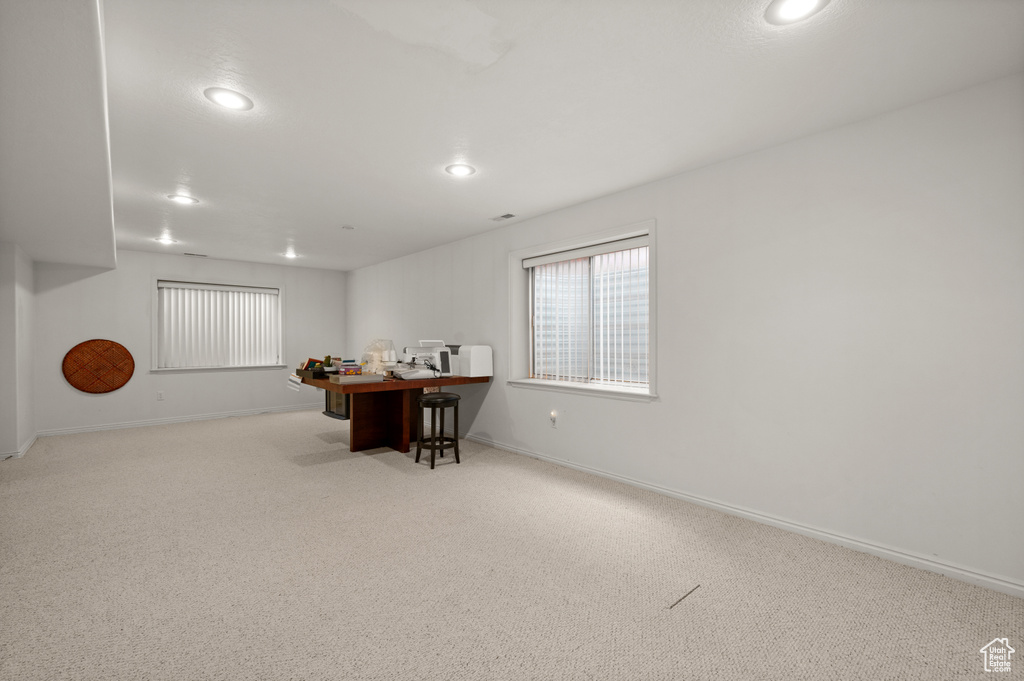 Carpeted dining space with recessed lighting, baseboards, and a desk